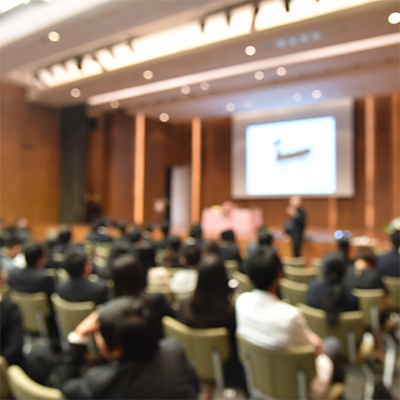 A speaker presenting to professionals.