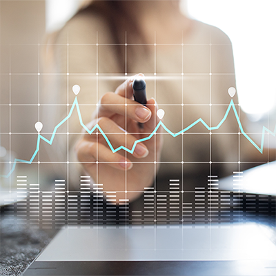 Woman marking a point on a translucent graph.